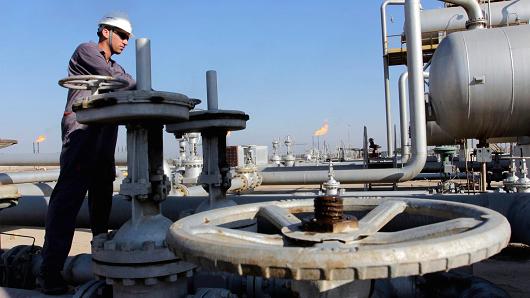 A laborer works at the Nahr Bin Umar oil field, southeast of Baghdad, Iraq..jpg